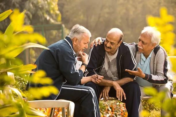 Senior residents sitting together on a comfortable couch, sharing a joyful moment,