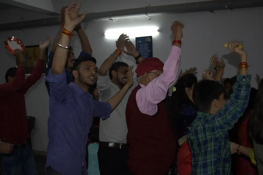 ISKCON members leading a devotional session at Ashirwad Elders Home