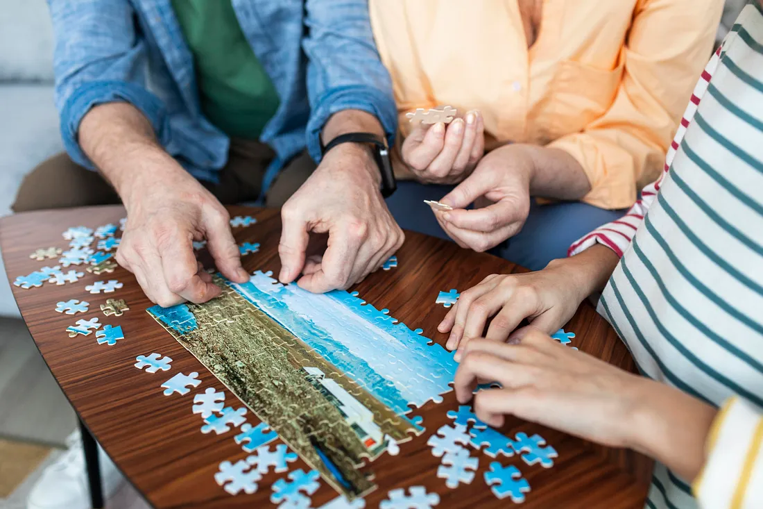 Residents solving a colorful jigsaw puzzle together