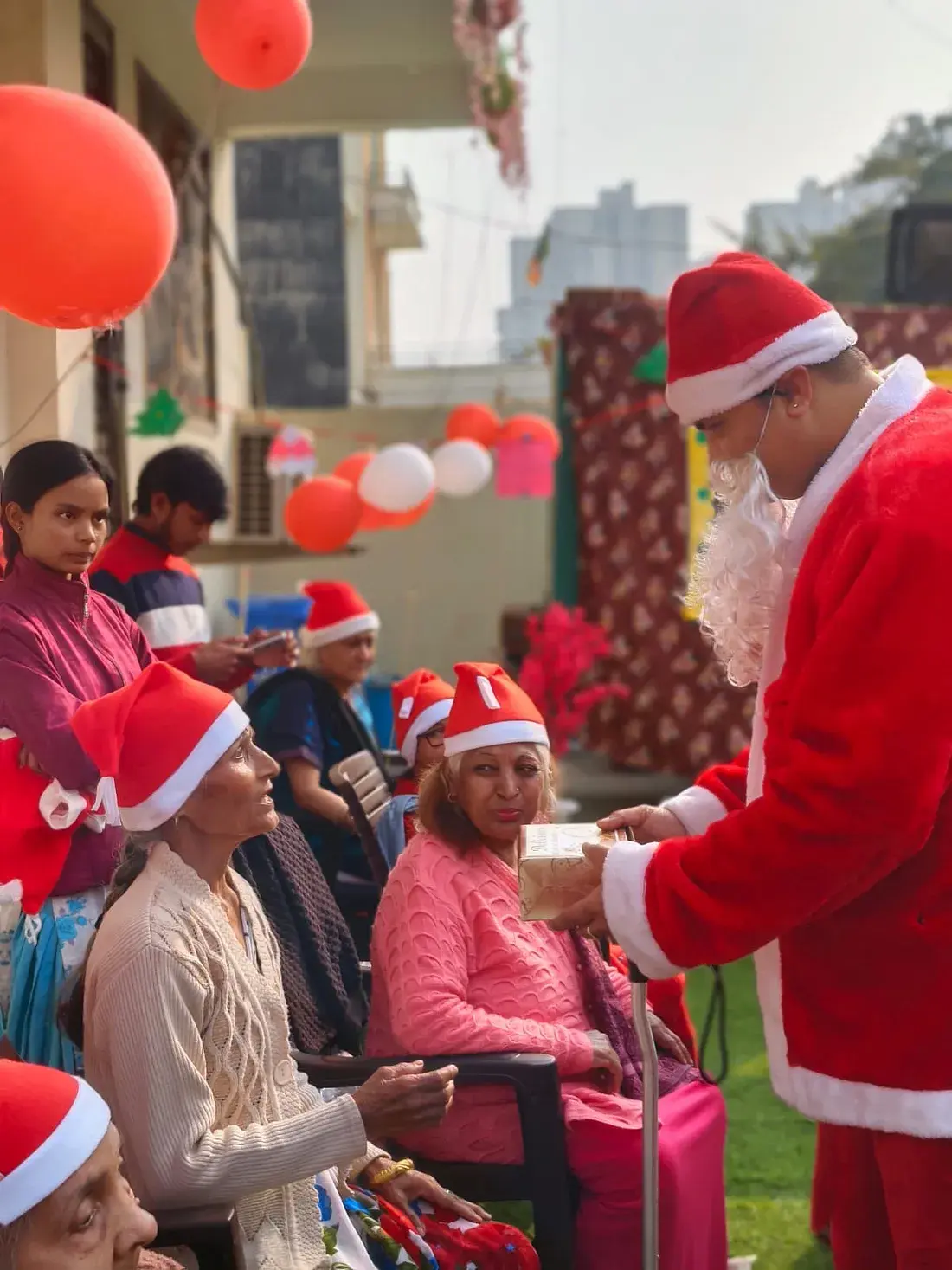 Residents unwrapping Christmas gifts at Ashirwad Elders Home