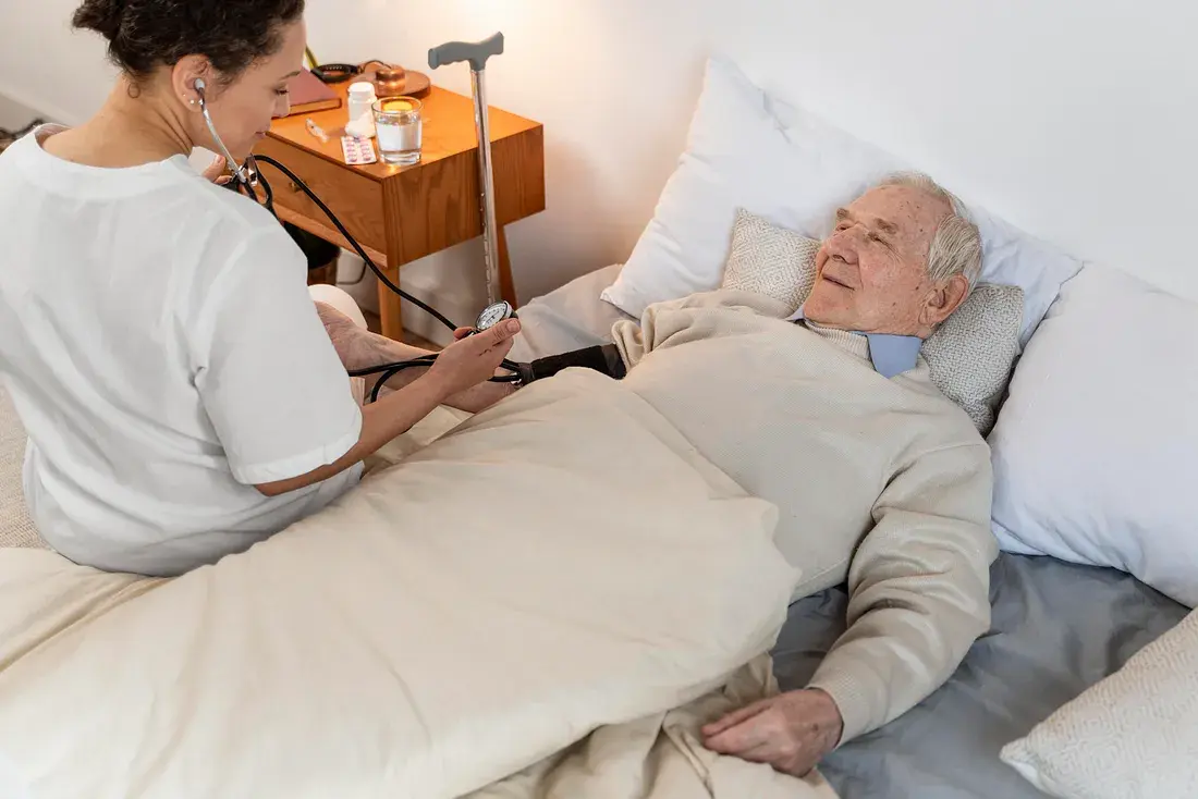 A dedicated healthcare professional attending to a senior at Ashirwad Elders Home, emphasizing 24/7 medical care and support