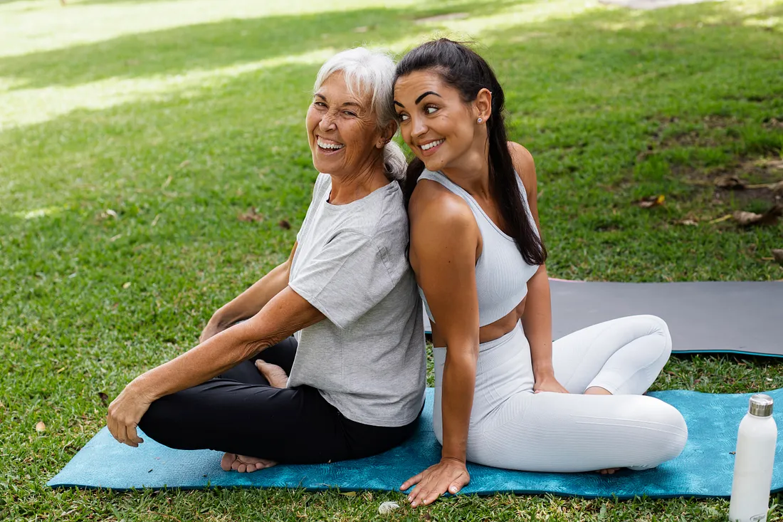 Senior citizens performing chair yoga with a professional instructor